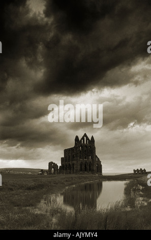 Whitby Abtei spiegelt sich im Teich und Silhouette gegen einen stürmischen Himmel Stockfoto