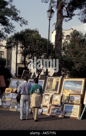 Der Mann und die Frau auf der Suche an Gemälde, auf dem Bazar Sabado wöchentliche Kunst und Handwerk Basar an der Plaza San Jacinto, San Angel, Mexiko Stadt Stockfoto