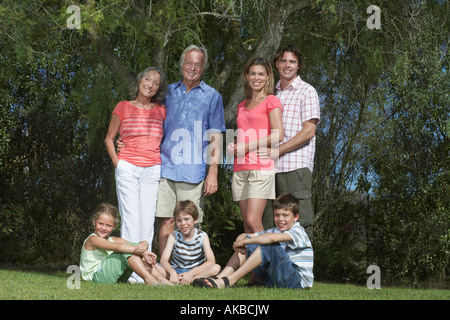 Porträt des drei-Generationen-Familie mit drei Kindern (6-11) unter Baum Stockfoto