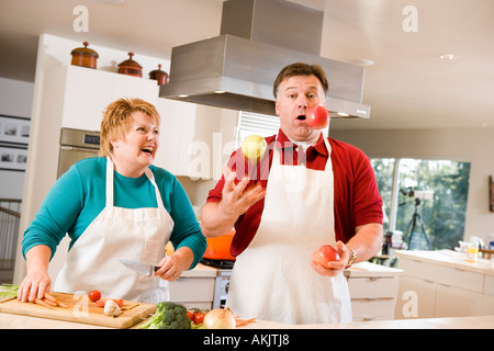 Jonglieren Obst mit lachenden Frau Mann Stockfoto