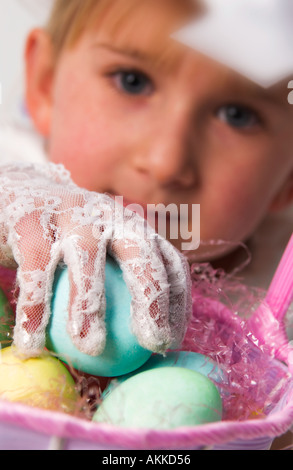 Mädchen-Kommissionierung-Eiern aus Korb Stockfoto