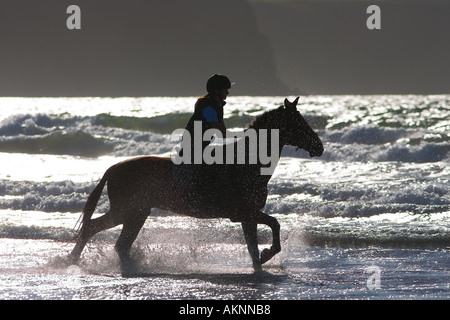 Junge Frau reitet auf einem Pferd Bucht auf breiten Haven Beach Pembrokeshire Wales Großbritannien Stockfoto