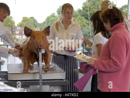 ein ganzes Schwein braten auf einem Grill Spieß mit Koch Stockfoto