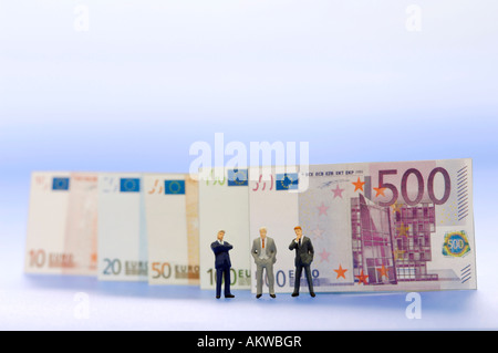 Unternehmer-Figuren, Geld im Hintergrund, Nahaufnahme Stockfoto