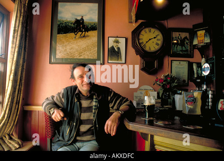 Ein lächelnder Mann entspannt sich, trinken einen Pint Stout von der Bar im Red Fox Inn, County Kerry, Irland Stockfoto