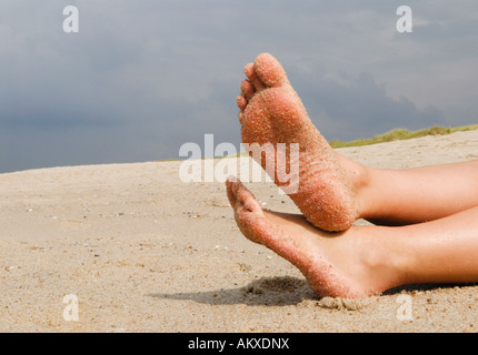 Weibliche Füße am Strand Stockfoto