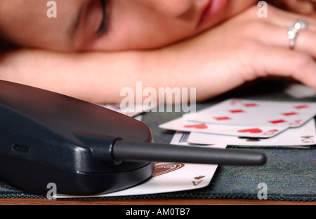 Das kaukasische Teenager-Mädchen schläft beim Solitär ein, während sie auf ihr Date in den USA wartet. Stockfoto