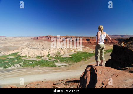 Frau auf der Suche von einem Aussichtspunkt über dem Colorado River, Colorado Plateau, Utah, USA Stockfoto