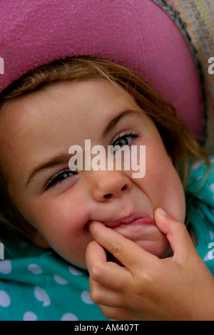 4 Jahre altes Mädchen in rosa Hut ziehen ein Gesicht Stockfoto