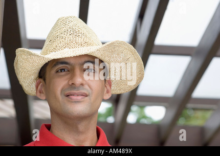 Porträt eines jungen Mannes trägt einen Strohhut Stockfoto