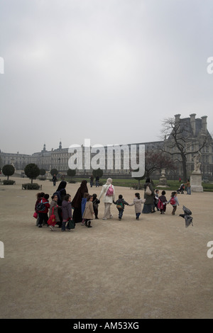 Junge muslimische Frauen und Kinder Kindergarten oder Kinderkrippe Gruppe im Tuileries Garten Paris Frankreich Stockfoto