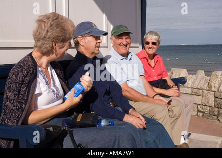 UK Dorset Swanage Rentner genießen Sonne im Tierheim oberhalb des Strandes Stockfoto