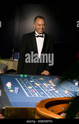 Gut gekleideter Mann Glücksspiel am Roulette-Tisch Stockfoto