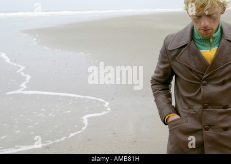 einsame blonde junge Mann zu Fuß am Strand, Dänemark Stockfoto