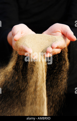 Sand, ausgeführt durch Hände als Symbol Mal in Folge verloren etc. Stockfoto