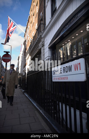 Fußgänger Spaziergänge vorbei an Gieves und Hawkes Shop in Savile Row London uk Stockfoto