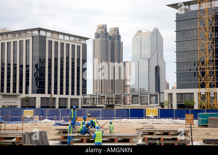 Handwerker vor Ort an der unvollendeten, unvollständige Hochhaus Gebäude; zugewanderten ausländischen Bau Projekt mitarbeiter Aufbau der neuen Dubai. UAE Stockfoto