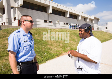 Justizvollzugsanstalt Offizier und Häftling sprechen auf dem Hof. Mittlere und maximale Sicherheit Gefängnis. Stockfoto