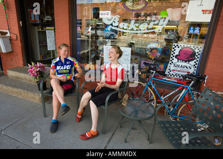 Zwei junge Frauen machen Sie eine Pause vom Radfahren auf Eisenbahn Straße Vermont USA Stockfoto