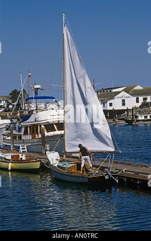 PORT TOWNSEND WASHINGTON STATE USA September Frau heben das Segel auf einem kleinen Schlauchboot im Hafen Stockfoto