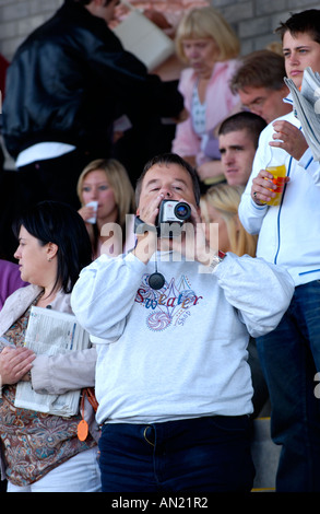 Racegoers in einem Familientag beobachten Pferderennen bei Chepstow Rennbahn Monmouthshire South Wales UK Stockfoto