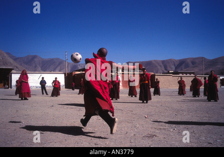 Tibetische Mönche nehmen sich Zeit vom Gebet, um Fußball zu spielen. Stockfoto
