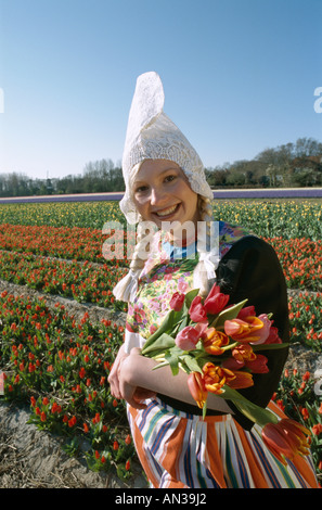 Blumenfelder / Tulpenfelder / Mädchen gekleidet in niederländischen Kostüm mit Tulpen, Lisse, Holland (Niederlande) Stockfoto