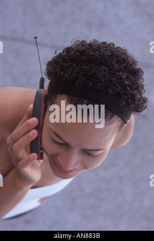 23 jährige gemischte Caucasian African American Frauen reden über Handy Stockfoto