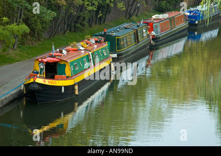 Horizontale erhöhten Blick auf mehrere traditionelle alte schmale Boote vertäut entlang der Grand Union Canal in der Sonne. Stockfoto