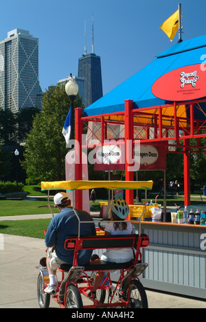 Touristen auf vier Rädern Fahrrad am Navy Pier in der Innenstadt von Chicago Illinois USA mit John Hancock Center im Hintergrund Stockfoto
