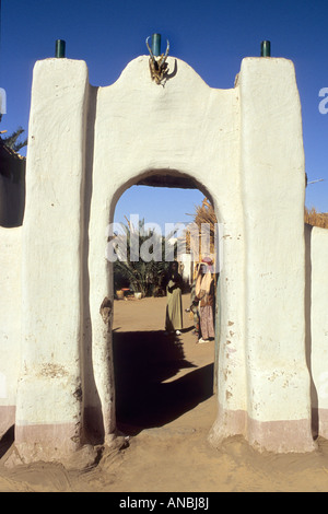 Einen Einblick in zwei Dorfbewohnern durch eine hohe Schlamm Ziegelbogen im Nubischen Stil der Architektur Stockfoto