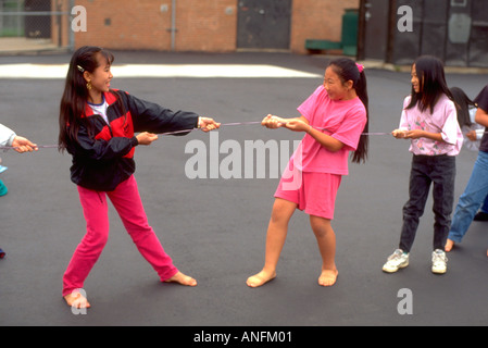 Asiatisch-amerikanische Studenten Alter 11 spielen Tauziehen in der Pause während Summer School. Holland Schule Minneapolis Minnesota USA Stockfoto