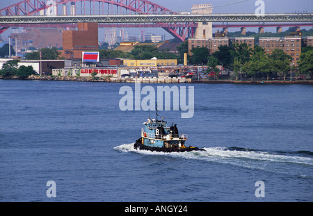 Schlepper auf dem East River, New York City. Handelsverkehr auf der New Yorker Wasserstraße. Robert F Kennedy Bridge oder Triborough Bridge und Hell Gate Bridge. USA Stockfoto