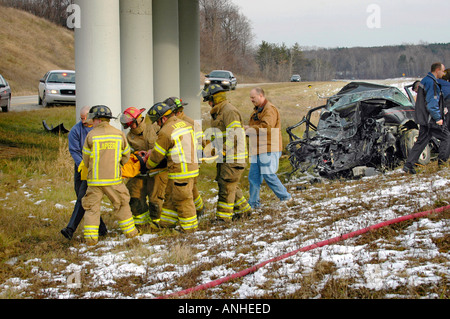Feuerwehrleute kümmern sich um verletzte Crash-Opfer eines Kopfes auf Automobil Absturz Stockfoto
