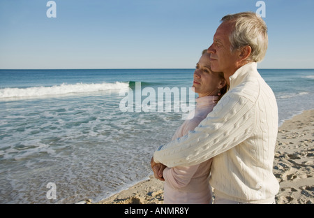 Paar am Strand umarmt Stockfoto