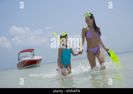 Mutter und Tochter mit Schnorcheln Ausrüstung zu Fuß im Wasser, Florida, Vereinigte Staaten Stockfoto