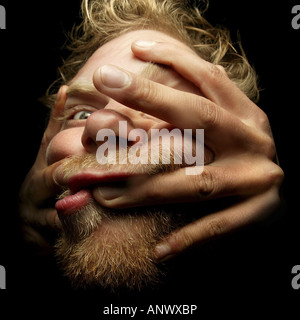 verrückter blonder Mann macht Grimassen Stockfoto