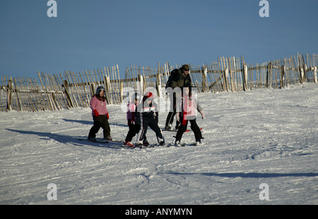 Vier Kinder und ein Mann Skifahren, Cairngorms National Park, Glenshee, Perthshire und Aberdeenshire, Schottland, Großbritannien, Europa Stockfoto