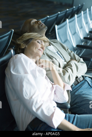 Paar, schlafen im Flughafen-lounge Stockfoto