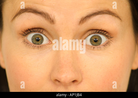 Frau mit Augen weit offen in Überraschung oder Schock Stockfoto