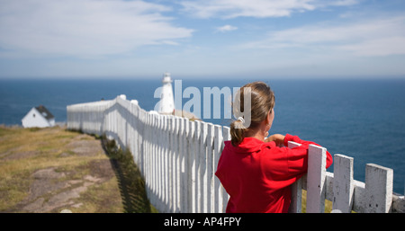 Frau stand am Zaun, am Leuchtturm Cape Spear, in Neufundland, Kanada. Stockfoto