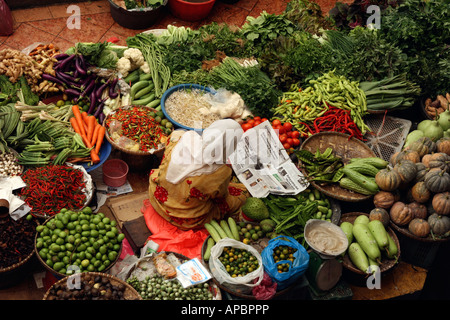 Weiblichen Markt Händler liest Zeitung während der Wartezeit für die Kunden am zentralen Markt Kota Bharu, Malaysia Stockfoto