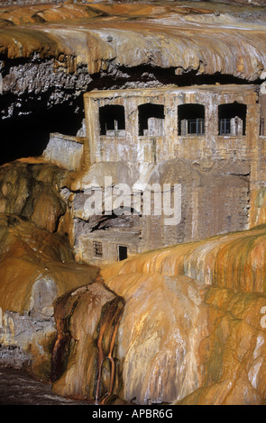 Verlassene Thermalbäder sind teilweise mit Travertin-Mineralvorkommen aus nahe gelegenen heißen Quellen in Puente del Inca, Provinz Mendoza, Argentinien, bedeckt Stockfoto