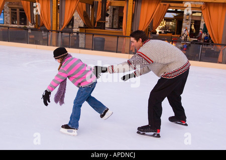 Ein Mädchen jagen ihr Vater während des Skatens in Northstar-Ski-Resort in der Nähe von Truckee, Kalifornien Stockfoto