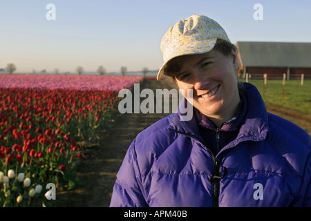 Im Bereich der rosa und roten Tulpen Mount Vernon Skagit Valley Skagit County Washington USA lächelnde Frau Stockfoto