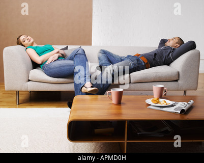 Junges paar entspannende auf sofa Stockfoto