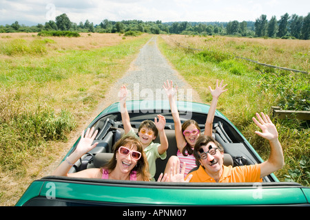 Begeisterte dumme Familie im Cabrio Stockfoto