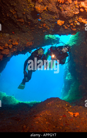 Blick aus der Höhle auf zwei Taucher Silhouette im Eingang Stockfoto