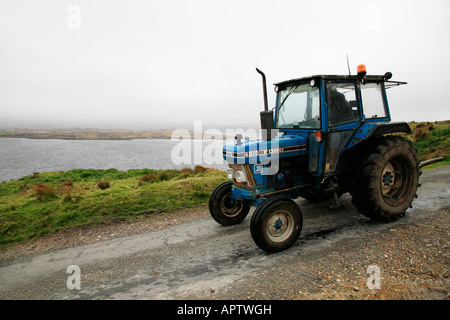 Traktor Ford auf eine Küstenstraße in Connemara, Irland Stockfoto