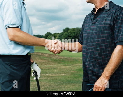 Golfer, die Hände schütteln Stockfoto